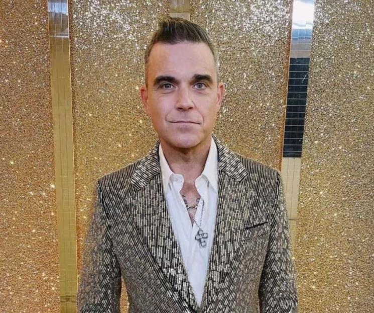 Calvicie le está ganando la batalla a Robbie Williams