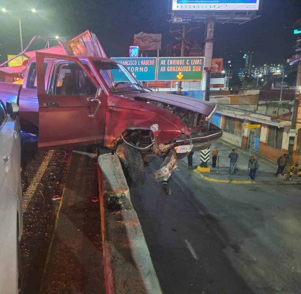 Tras ser impactados por otro vehículo, el conductor de una camioneta se estrelló en el barandal de protección del puente de Gonzalitos y Madero, y quedó colgado del mismo, en Monterrey, donde su acompañante resultó lesionada, así como tres mujeres que estaban abajo y les cayó parte del escombro.